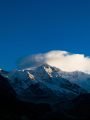 A breathtaking view of the snowy mountain summit on a blue sky background